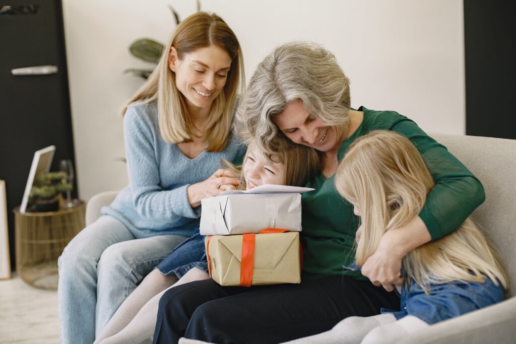 A happy grandparent gifting to grandchildren